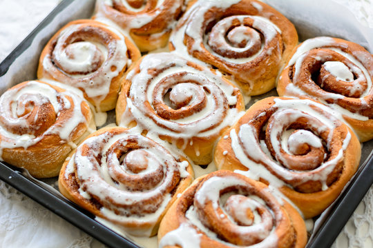 Freshly baked cinnamon rolls with white icing